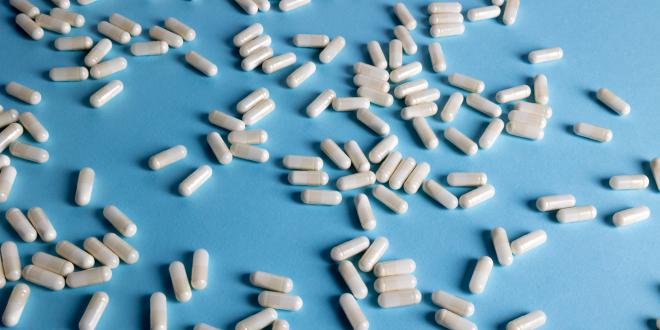 White capsules on a light blue background. 