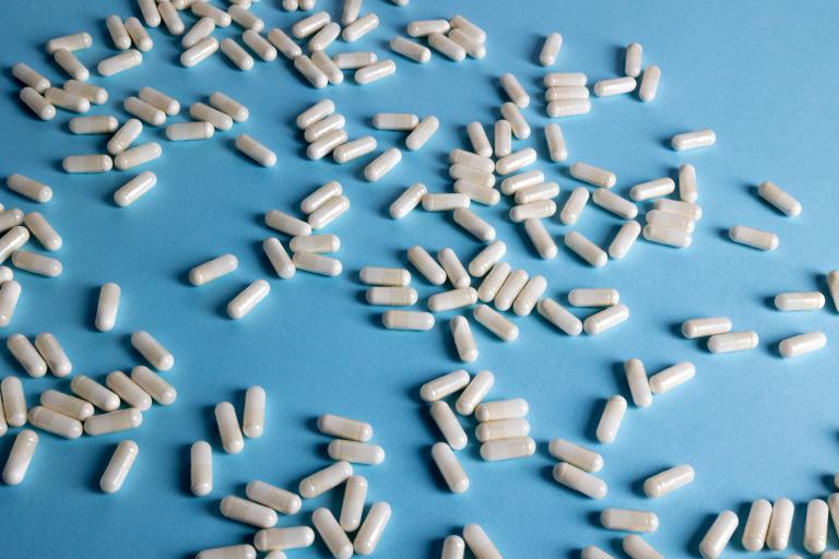 White capsules on a light blue background. 